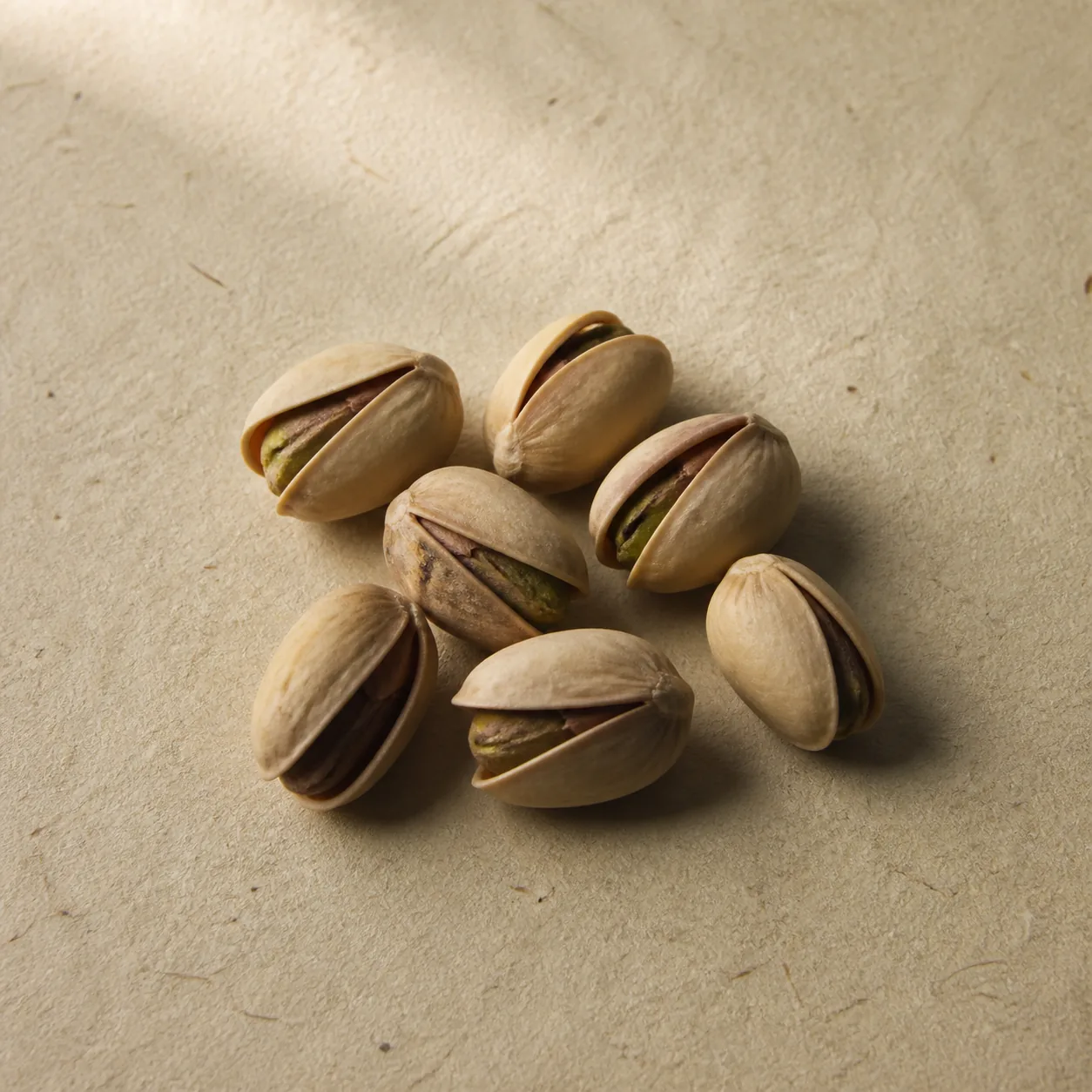 Naturally opened pistachios on unbleached paper